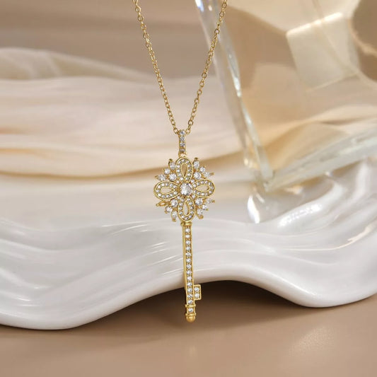 Gold key necklace with sparkling zircon details and ornate design