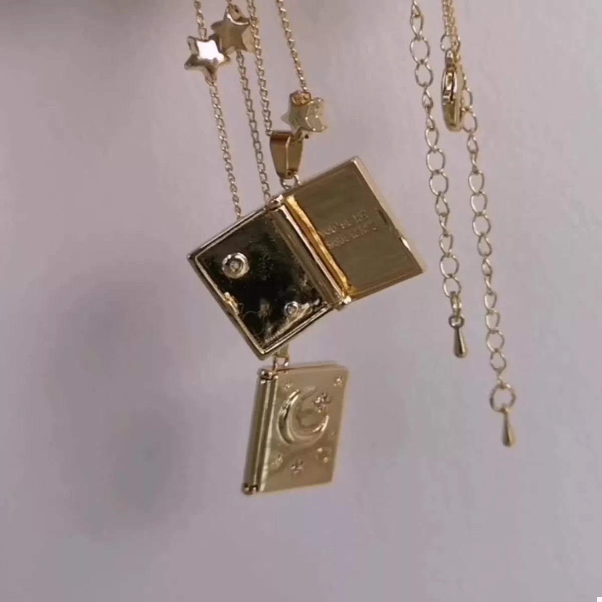 18K gold-plated star and moon locket necklace with zircon details and “You’re My Soulmate” engraving inside.