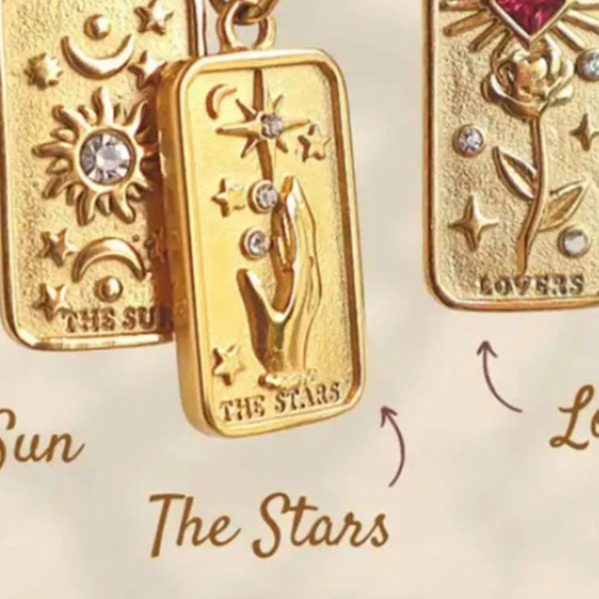 18K gold-plated tarot card necklace featuring the sun, the stars, and lovers tarot card.