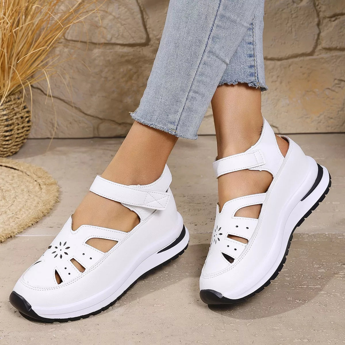 White cutout Mary Jane shoes with adjustable ankle strap, low heel, PU leather material, rubber sole, and casual everyday styling.