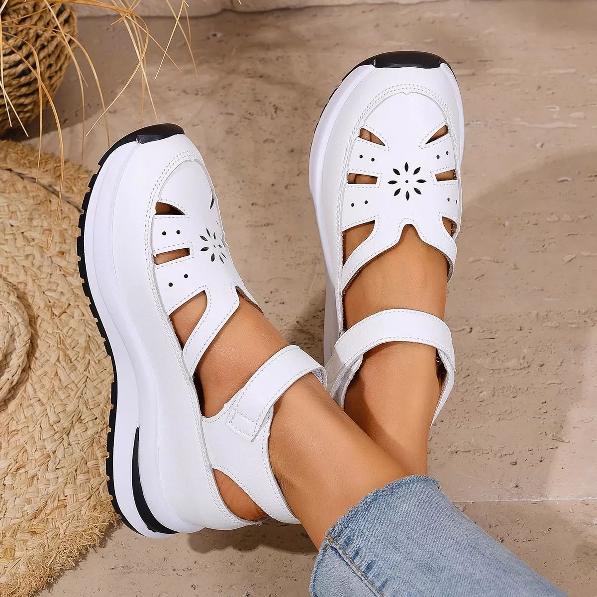 White cutout Mary Jane shoes with adjustable ankle strap, low heel, PU leather material, rubber sole, and casual everyday styling.