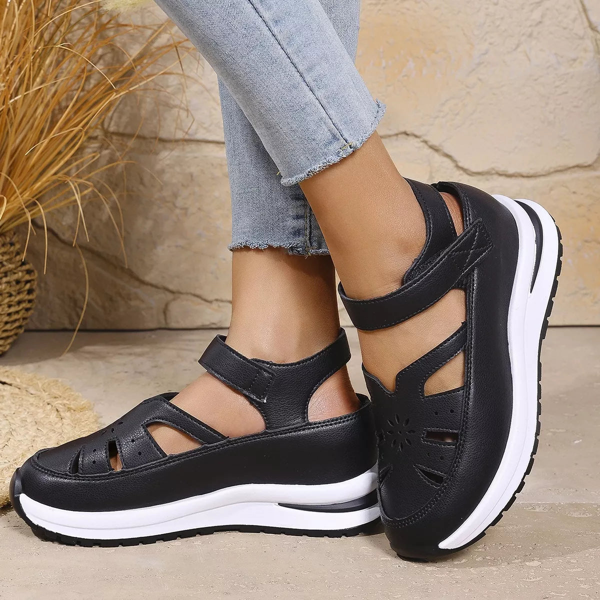 Black cutout Mary Jane shoes with adjustable ankle strap, low heel, PU leather material, rubber sole, and casual everyday styling.