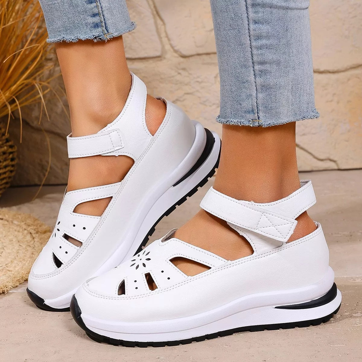 White cutout Mary Jane shoes with adjustable ankle strap, low heel, PU leather material, rubber sole, and casual everyday styling.