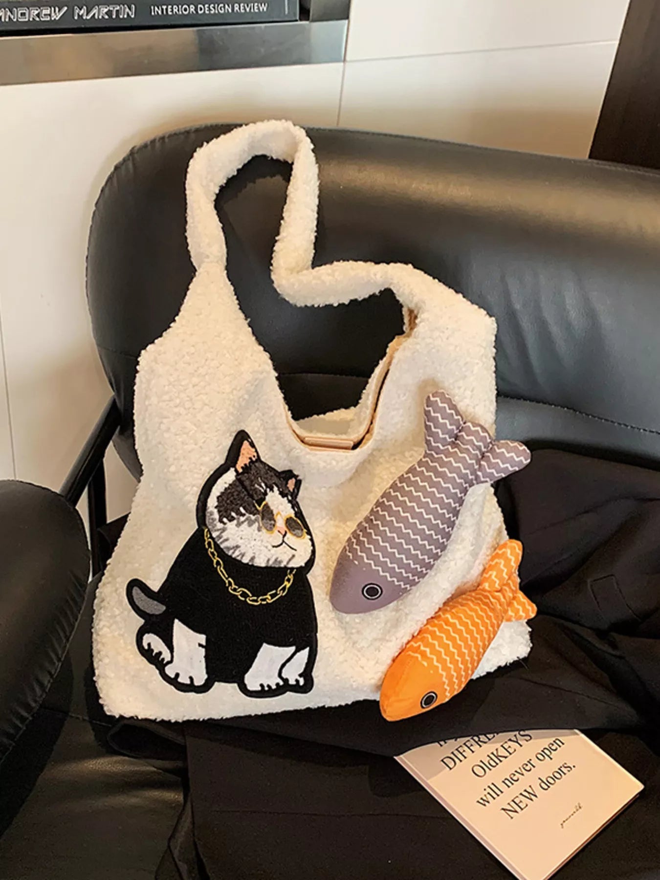 Fluffy white plush shoulder bag featuring an embroidered cool cat wearing sunglasses with playful fish accents.