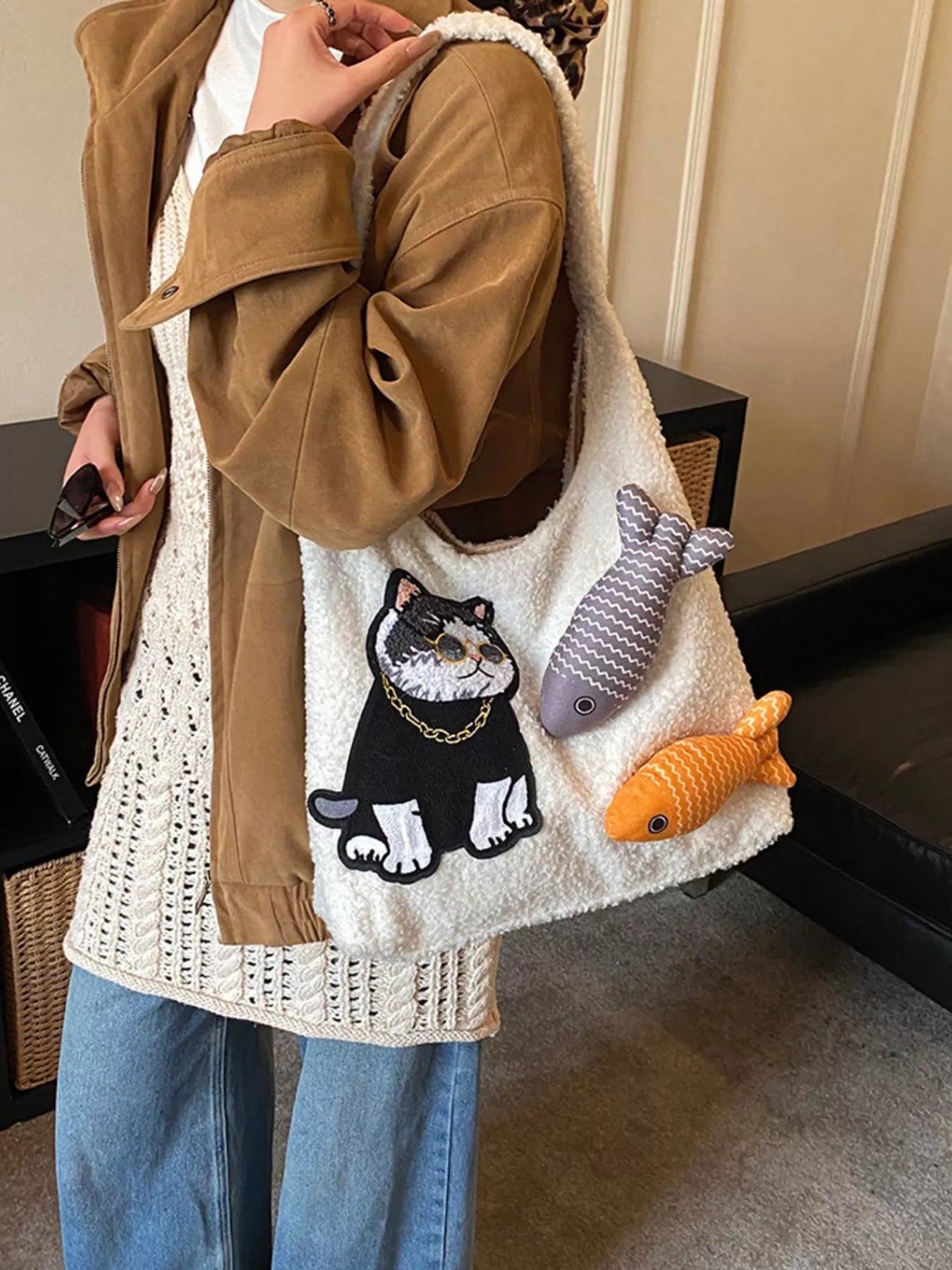 Fluffy white plush shoulder bag featuring an embroidered cool cat wearing sunglasses with playful fish accents.