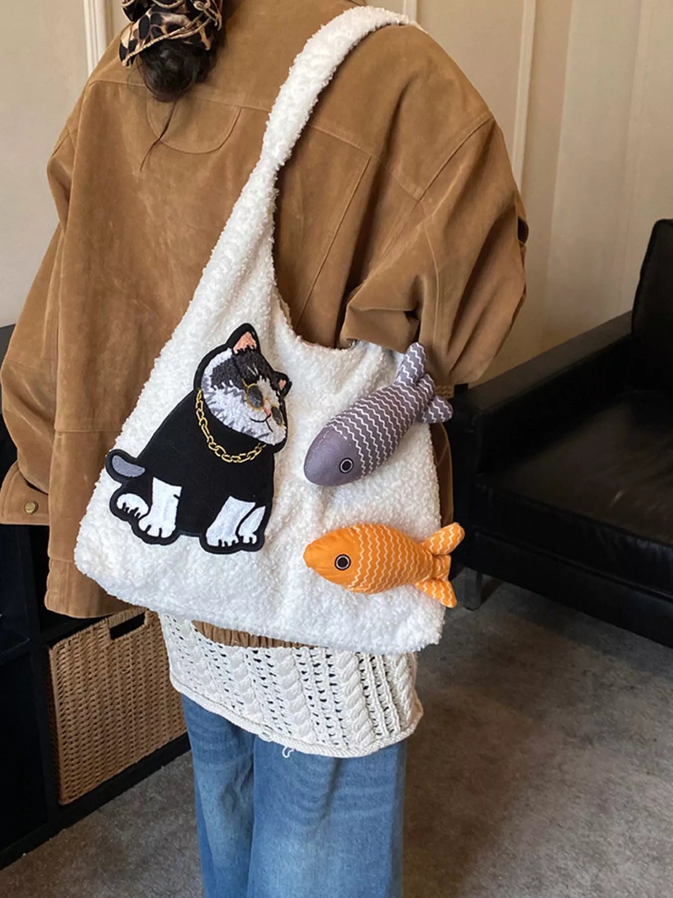 Fluffy white plush shoulder bag featuring an embroidered cool cat wearing sunglasses with playful fish accents.
