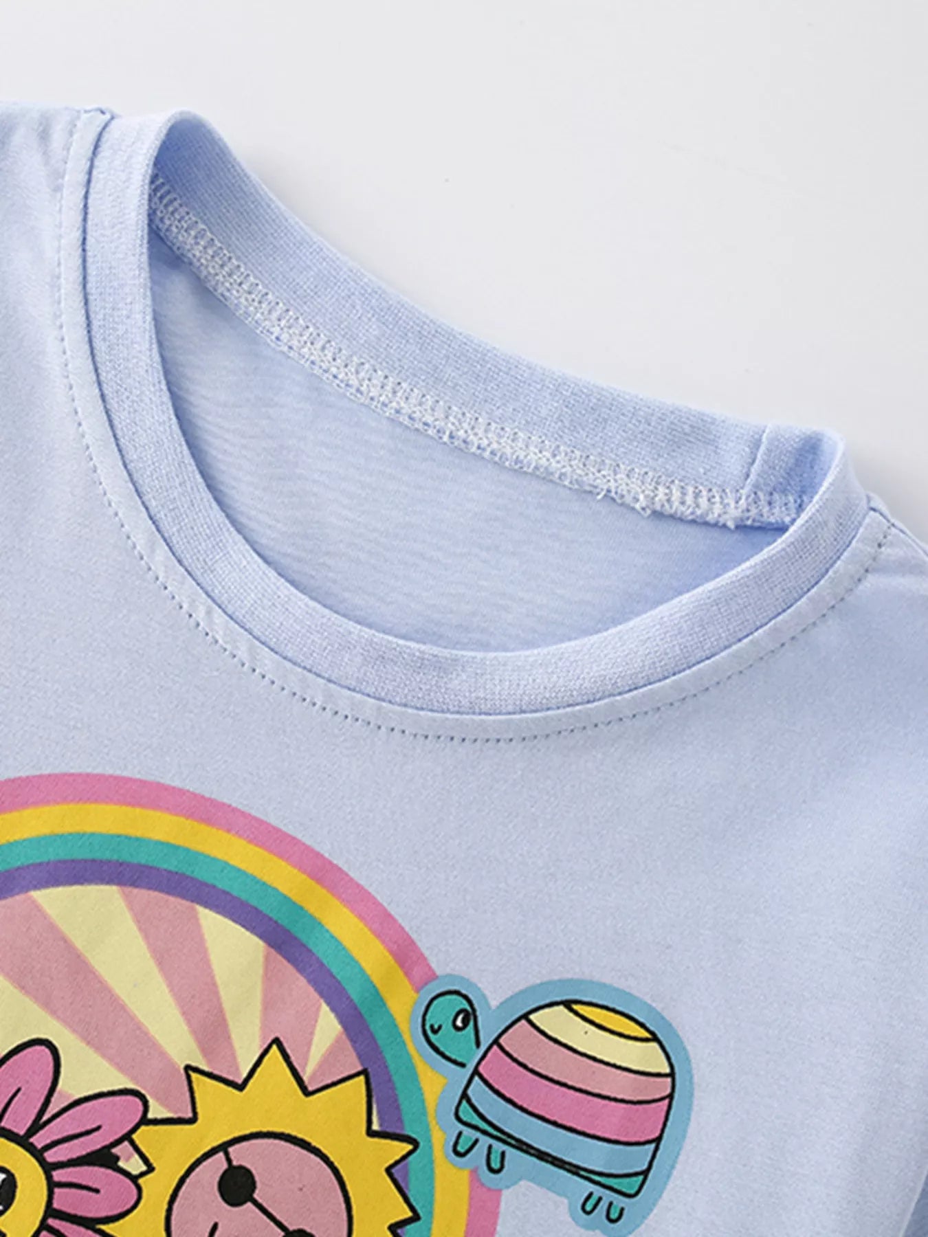 Kids light blue graphic tee with rainbow retro print