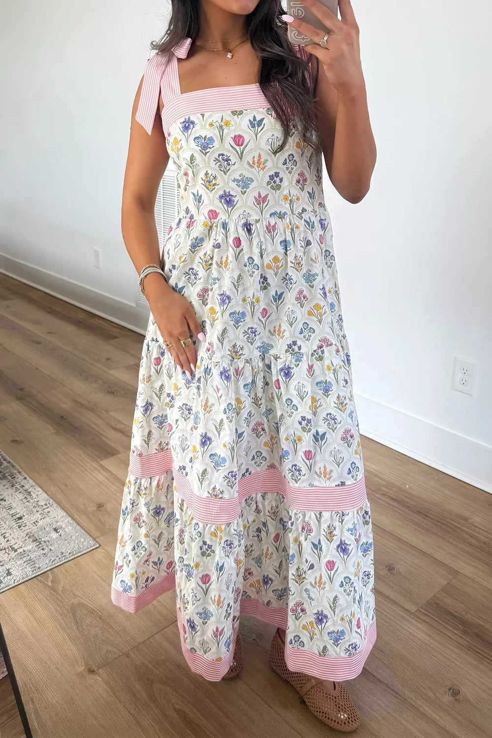 Floral tiered midi dress with pink tie-shoulder detail, contrast trim, flowy skirt, and breezy garden-inspired style.
