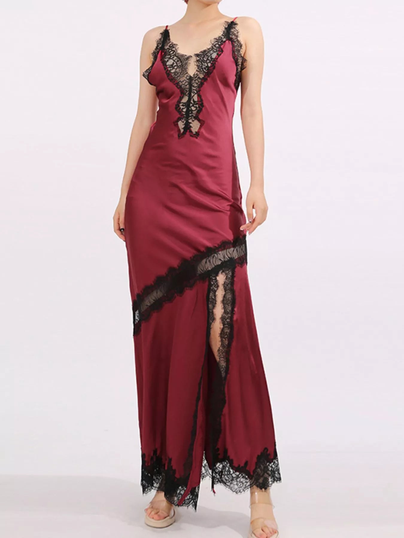 Crimson satin gown with black lace trim, deep V neckline, and thigh-high slit.