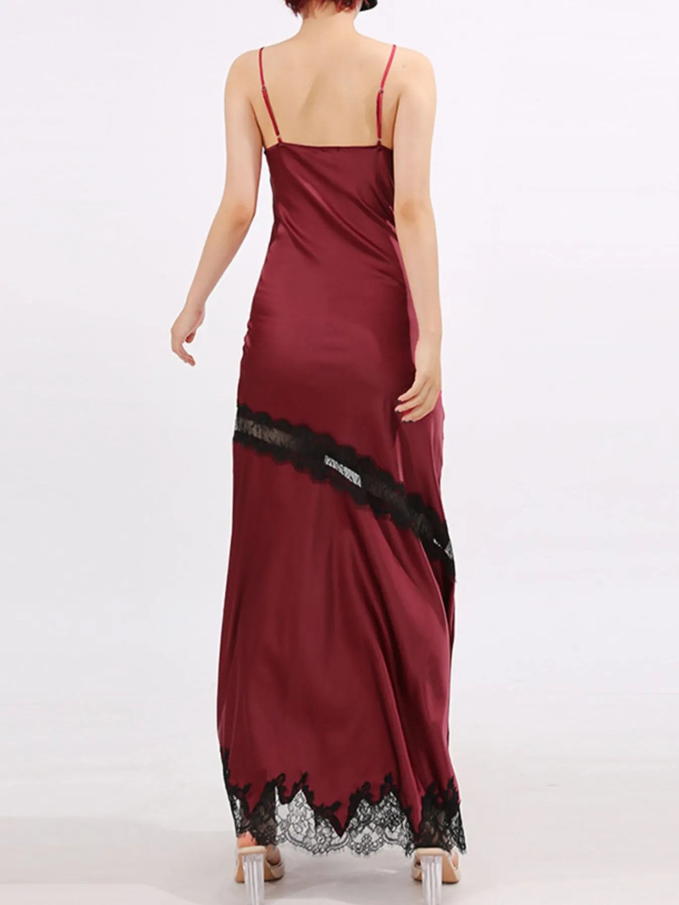 Crimson satin gown with black lace trim, deep V neckline, and thigh-high slit.