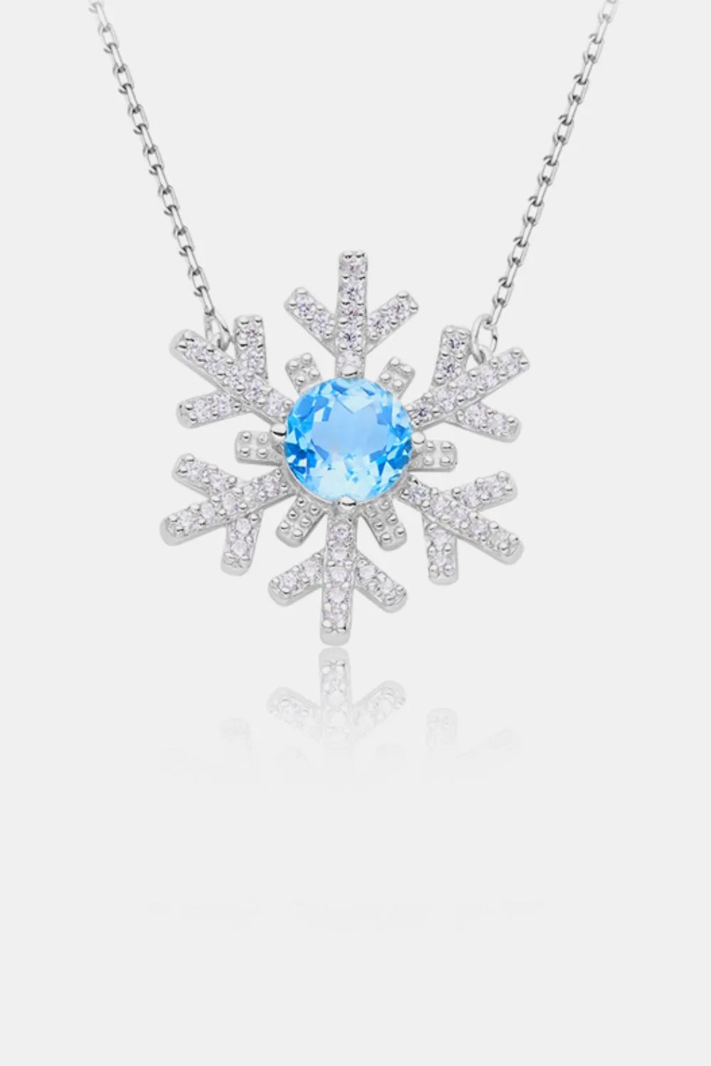 Sterling silver snowflake pendant necklace with a topaz center stone.
