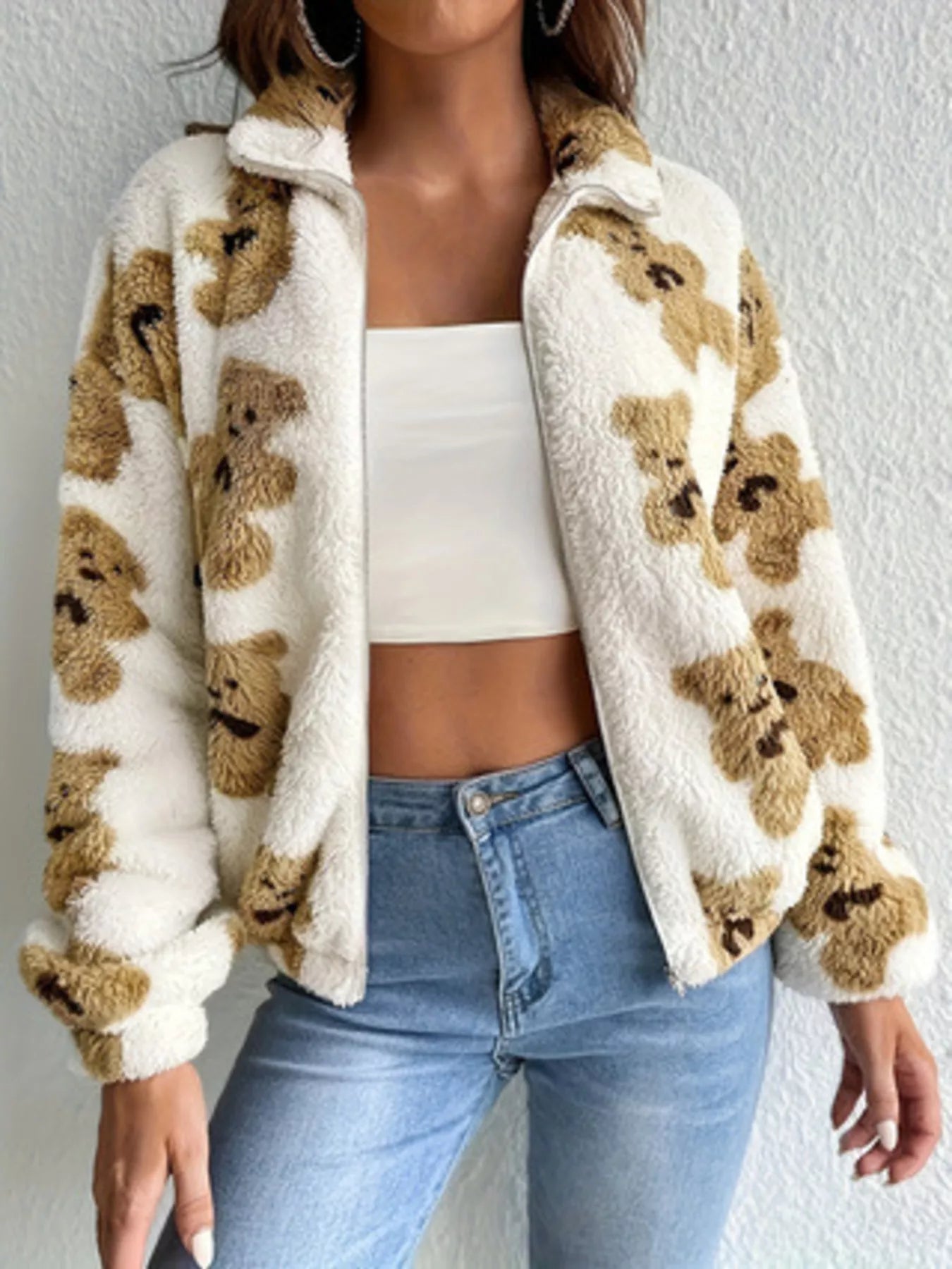 Plush teddy zip-up jacket with bear pattern styled with denim jeans