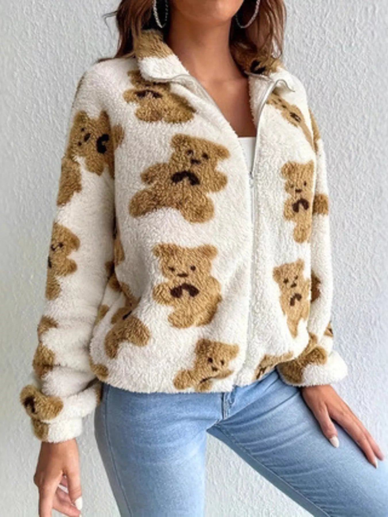 Plush teddy zip-up jacket with bear pattern styled with denim jeans