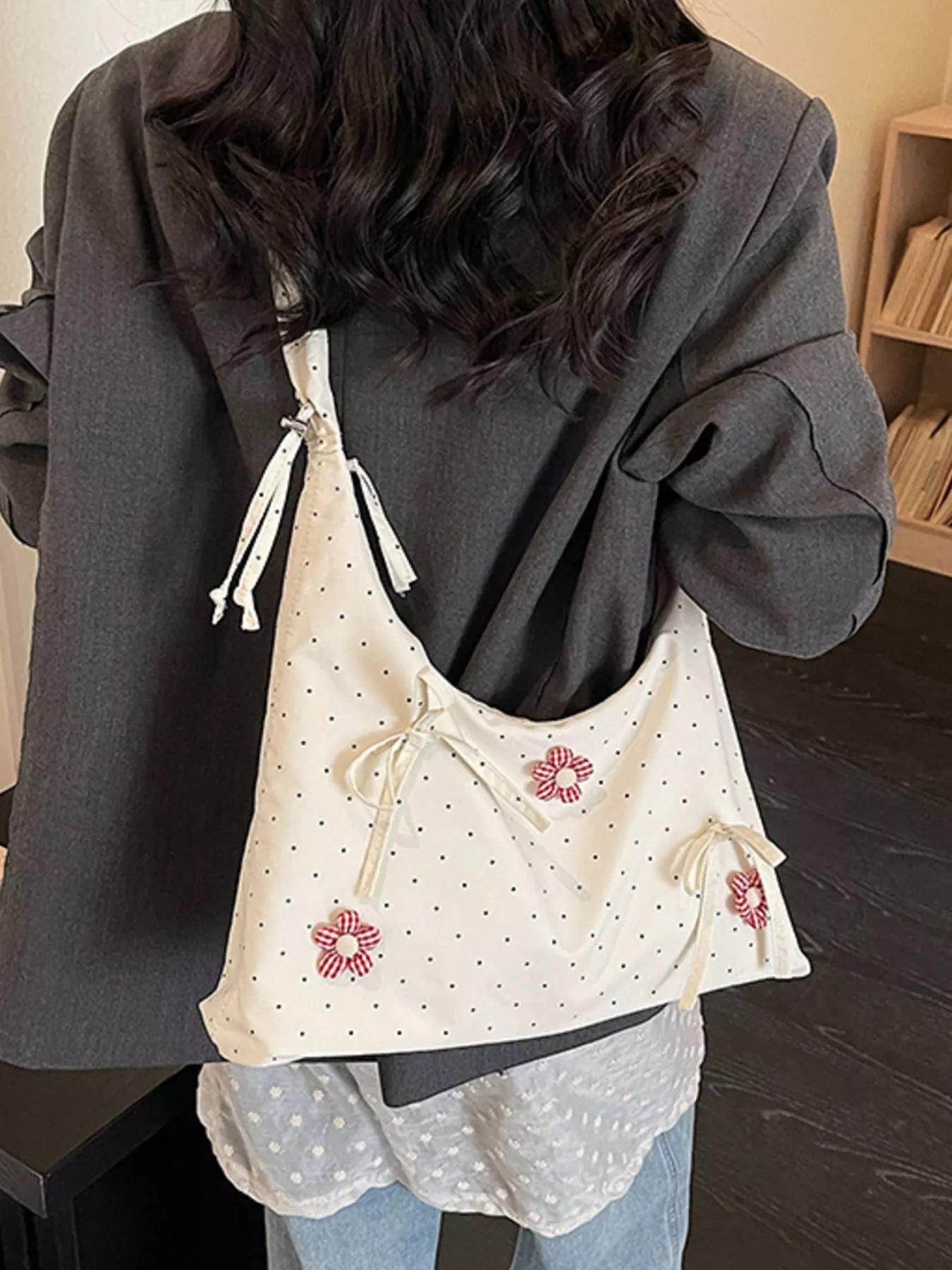 Medium shoulder bag with daisy floral appliqués, bow details, dotted fabric, ruffled strap, and soft cottagecore styling.