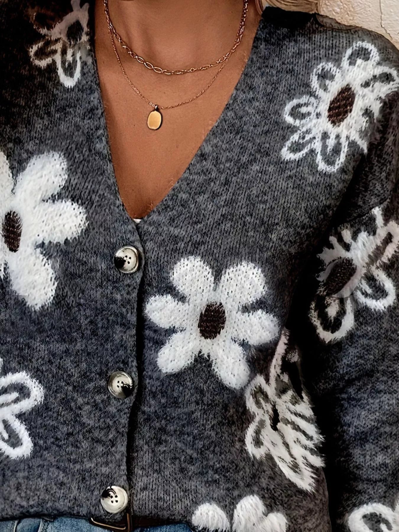 Black button-front cardigan with white daisy print styled with jeans