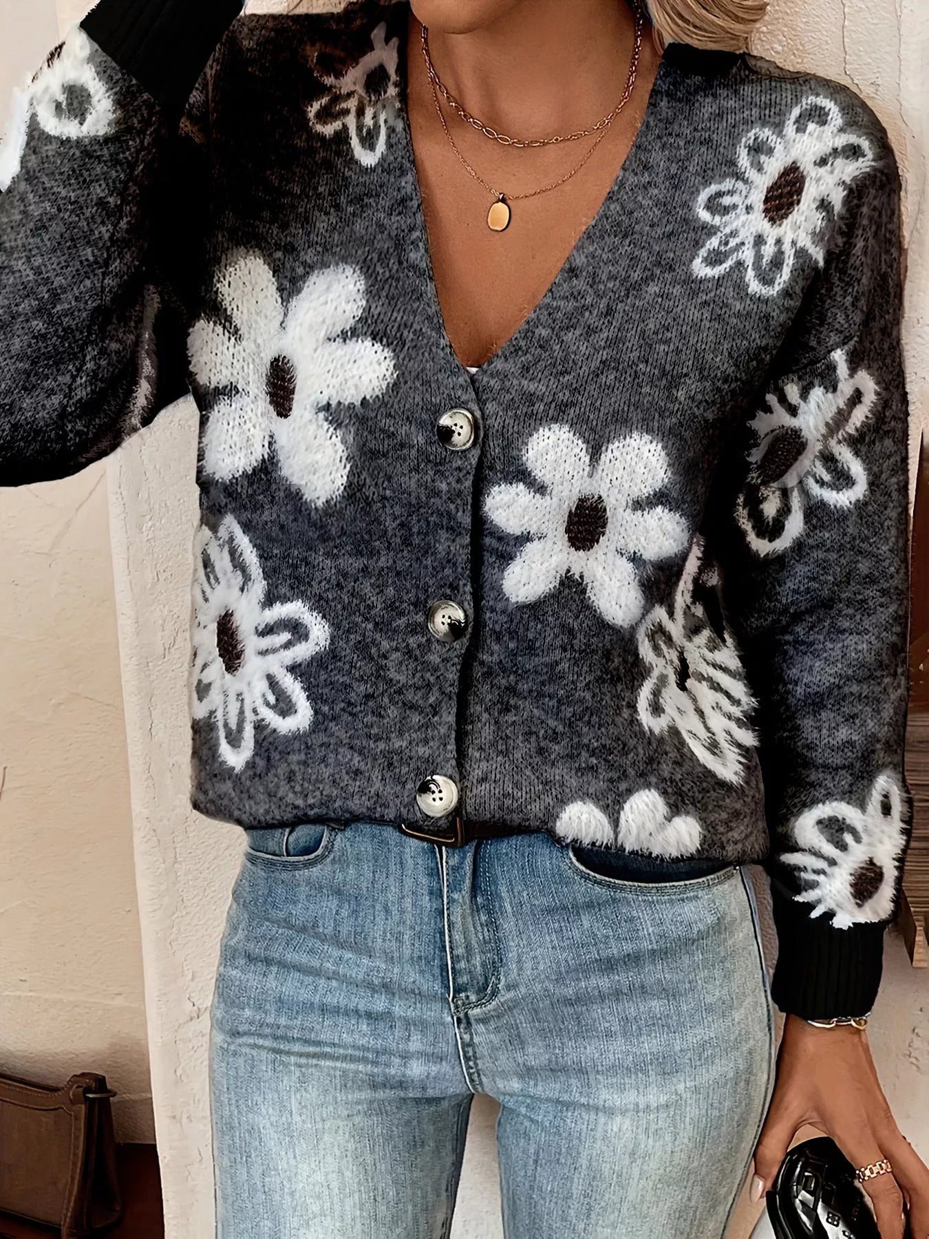 Black button-front cardigan with white daisy print styled with jeans