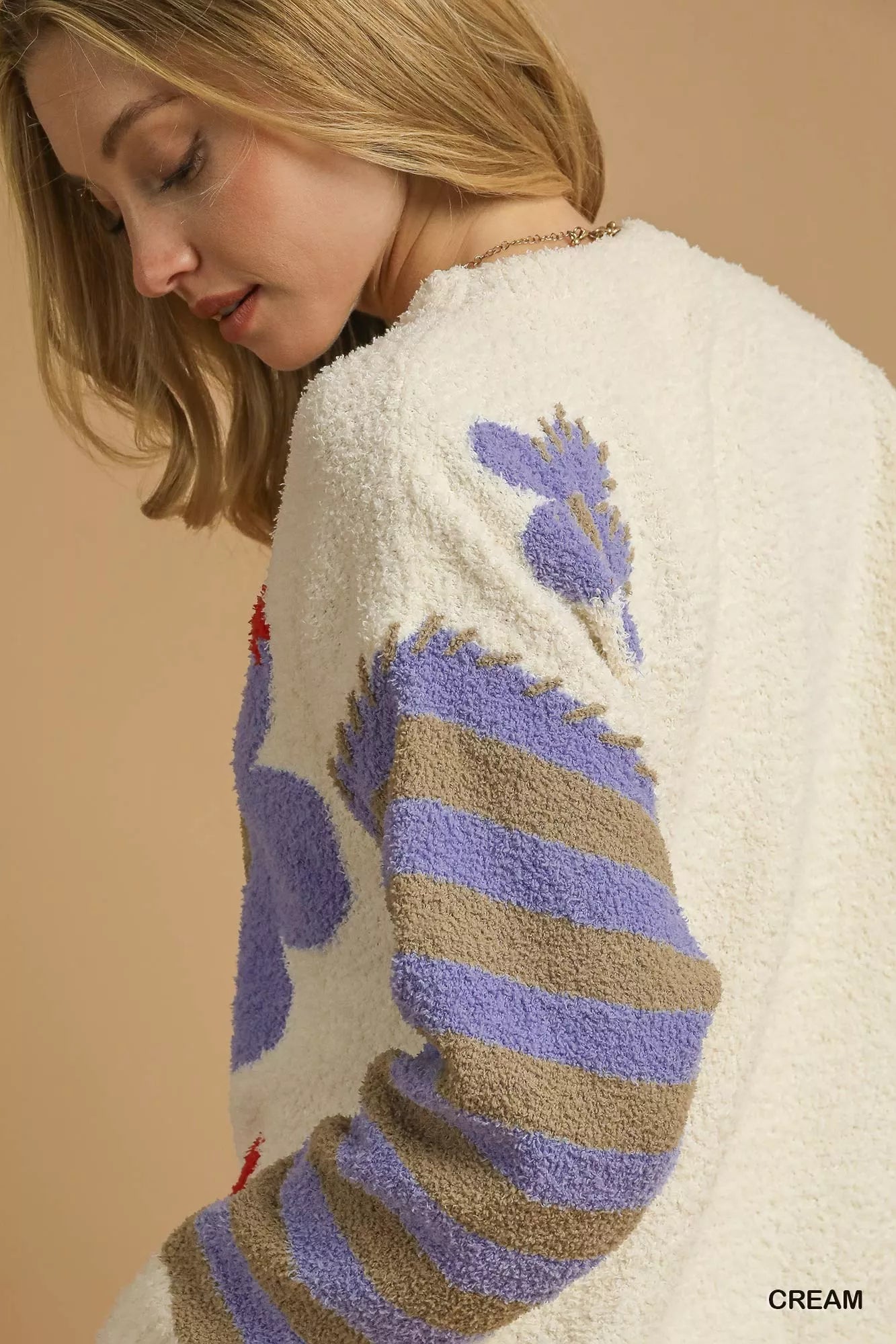 Daisy Dreams Sweater with oversized jacquard floral design and striped sleeves in cream and purple