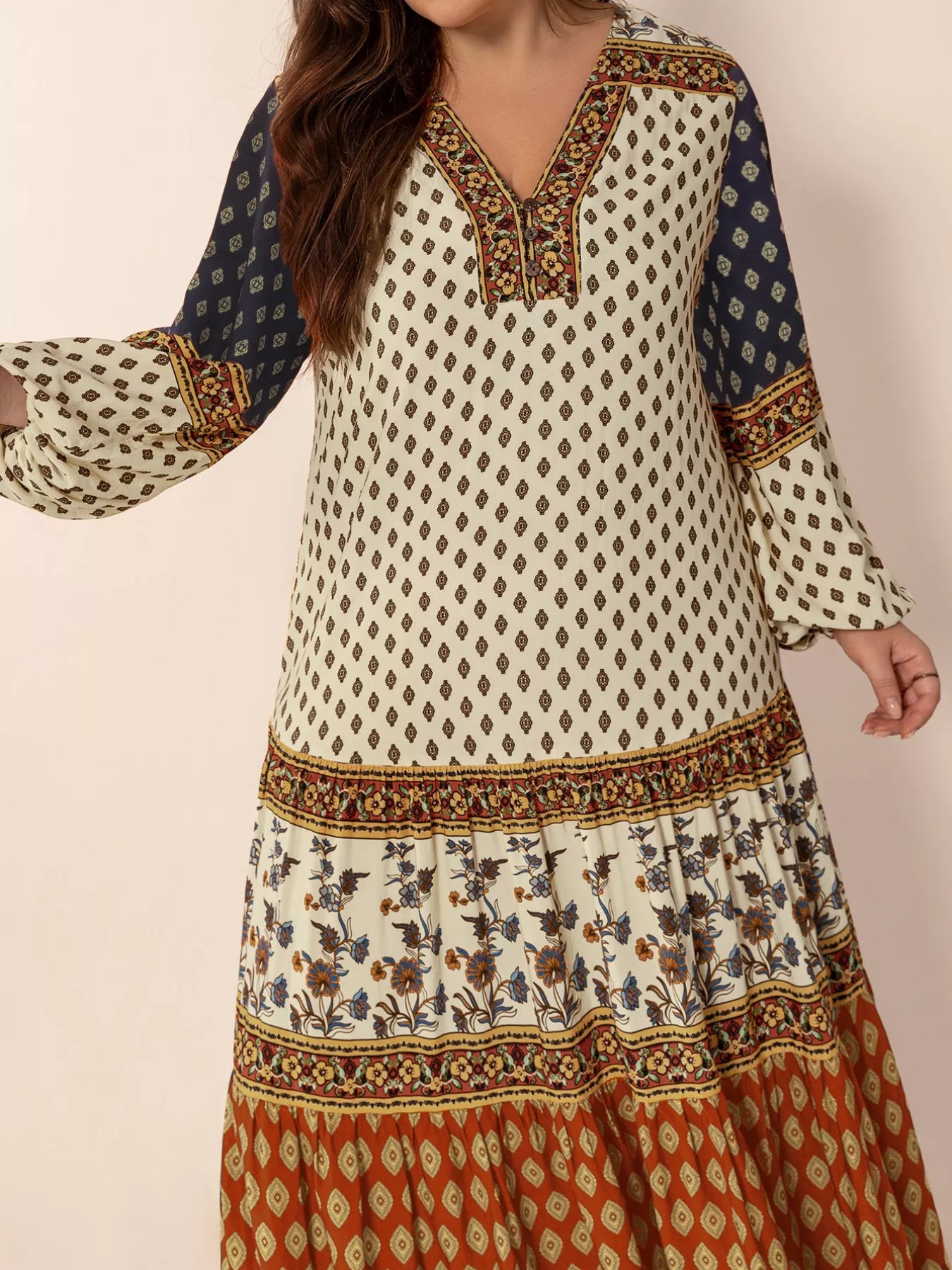 Plus size boho patchwork maxi dress with diamond print, floral panels, and ruched button detail