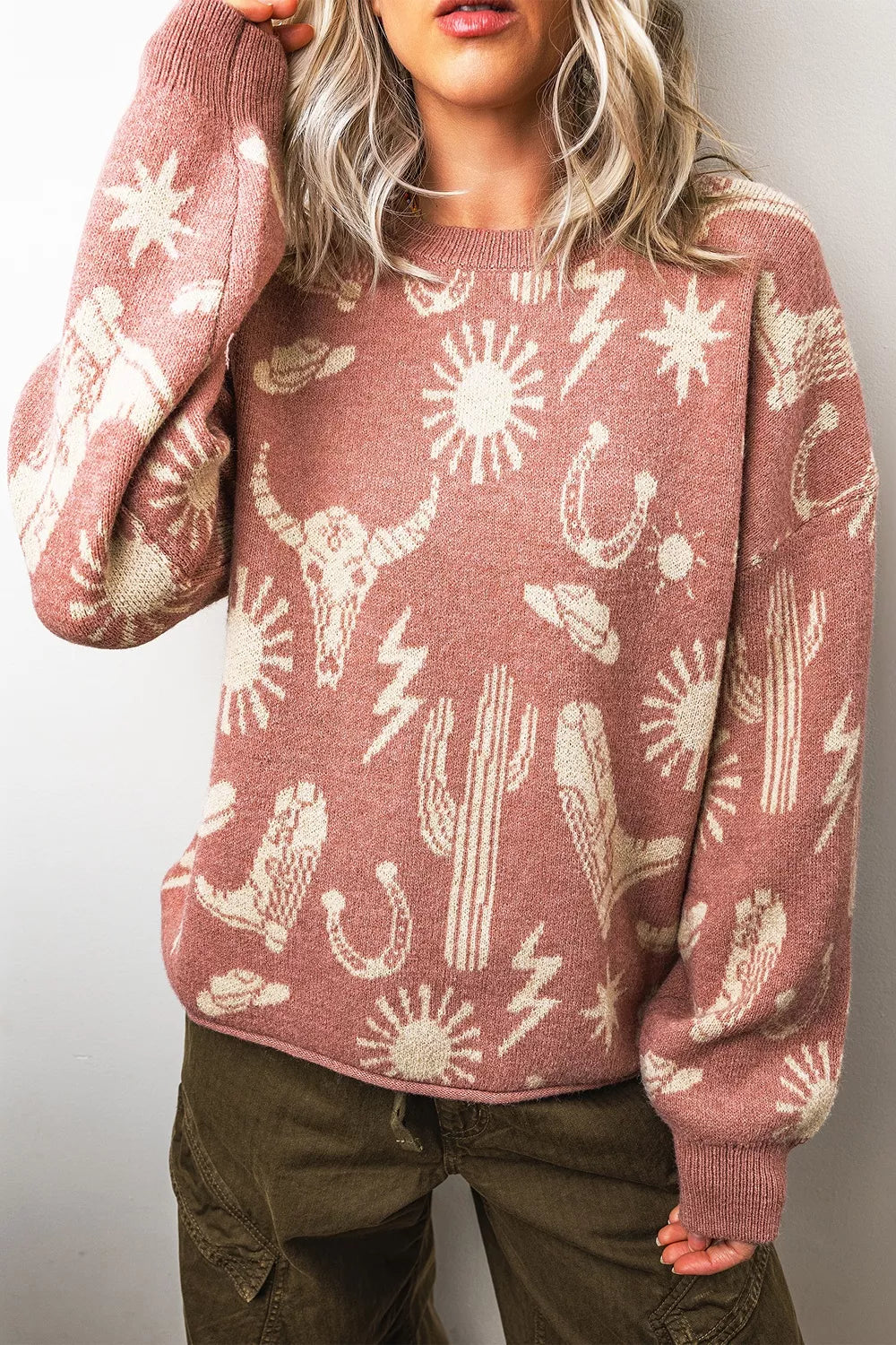 Boho western knit sweater with desert motifs, ribbed neckline and cuffs, relaxed long sleeves, and slightly stretchy acrylic-blend fabric.