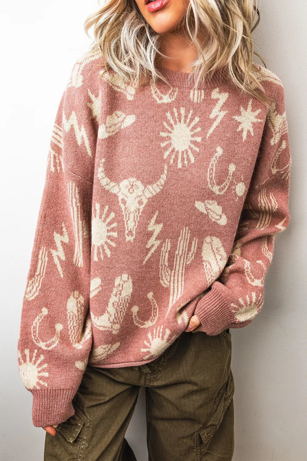 Boho western knit sweater with desert motifs, ribbed neckline and cuffs, relaxed long sleeves, and slightly stretchy acrylic-blend fabric.