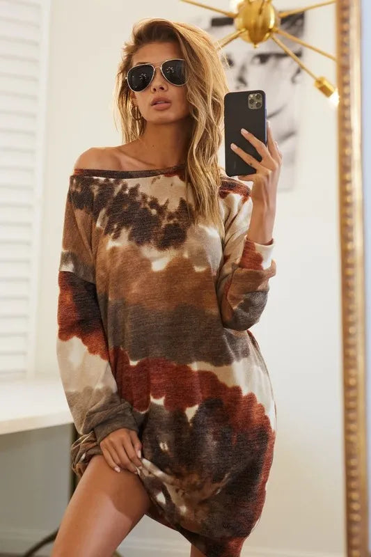 Woman wearing a neutral tie-dye knit dress with long sleeves and side pocket