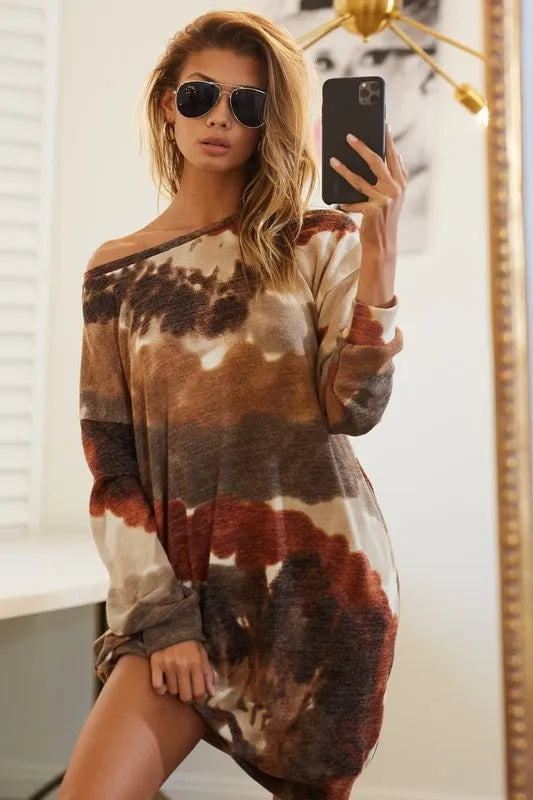 Woman wearing a neutral tie-dye knit dress with long sleeves and side pocket