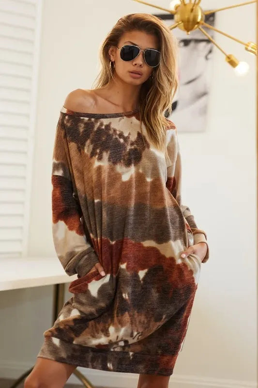 Woman wearing a neutral tie-dye knit dress with long sleeves and side pocket