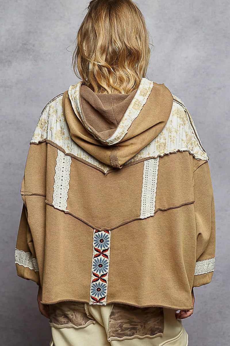 Vintage-washed tan hoodie with patchwork floral accents, lace trim, and balloon sleeves.