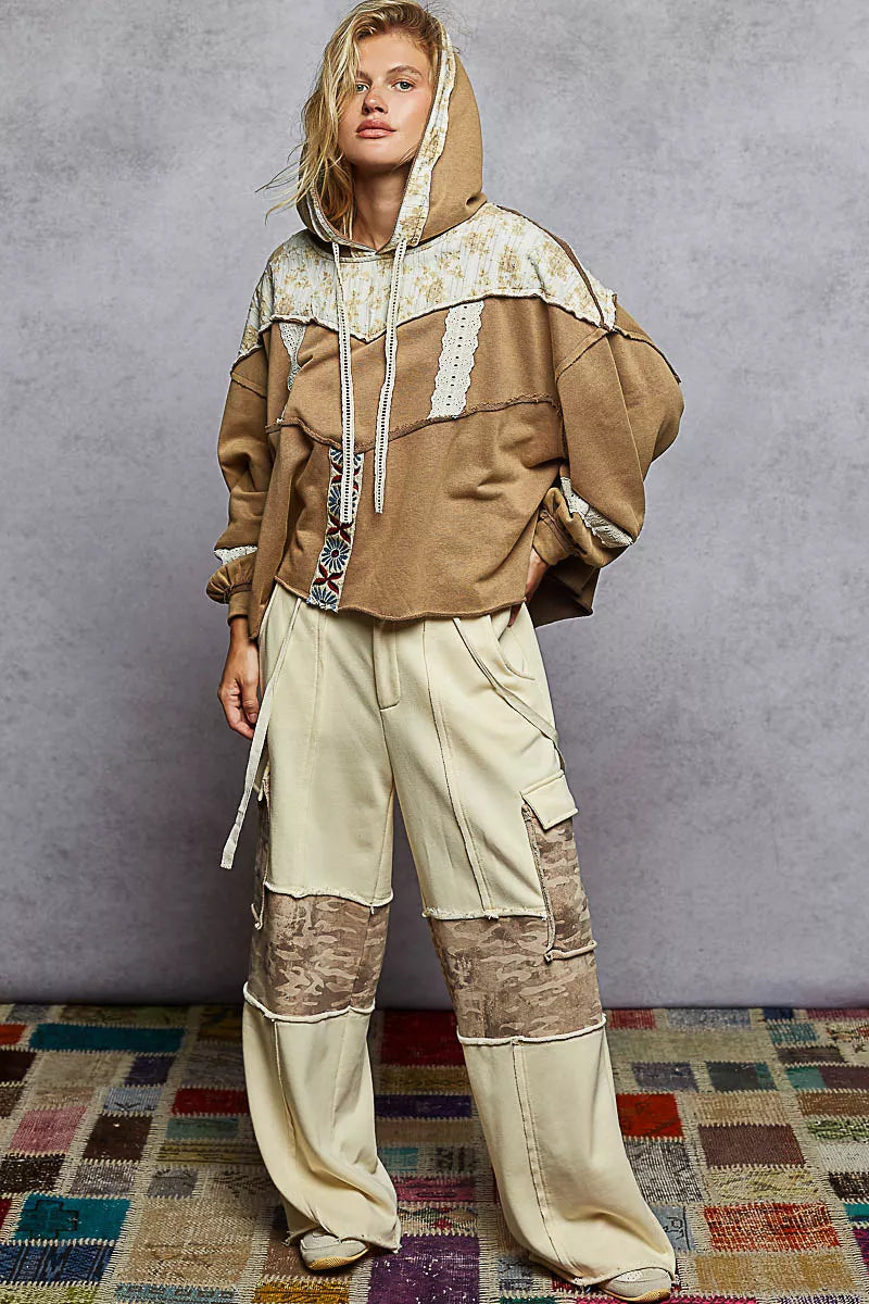 Vintage-washed tan hoodie with patchwork floral accents, lace trim, and balloon sleeves.