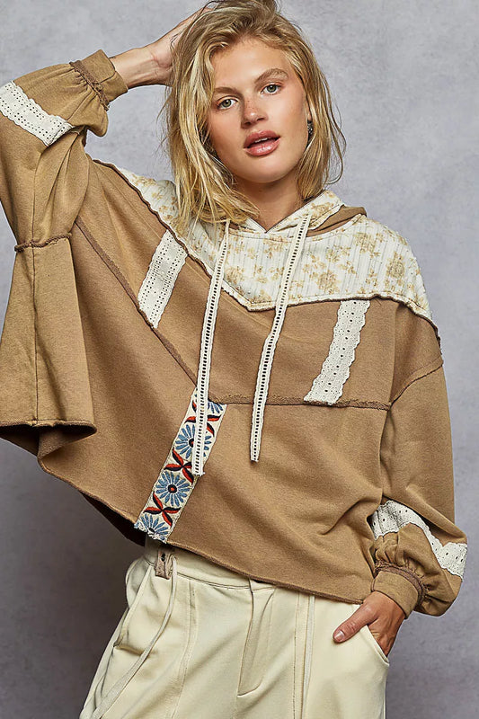 Vintage-washed tan hoodie with patchwork floral accents, lace trim, and balloon sleeves.