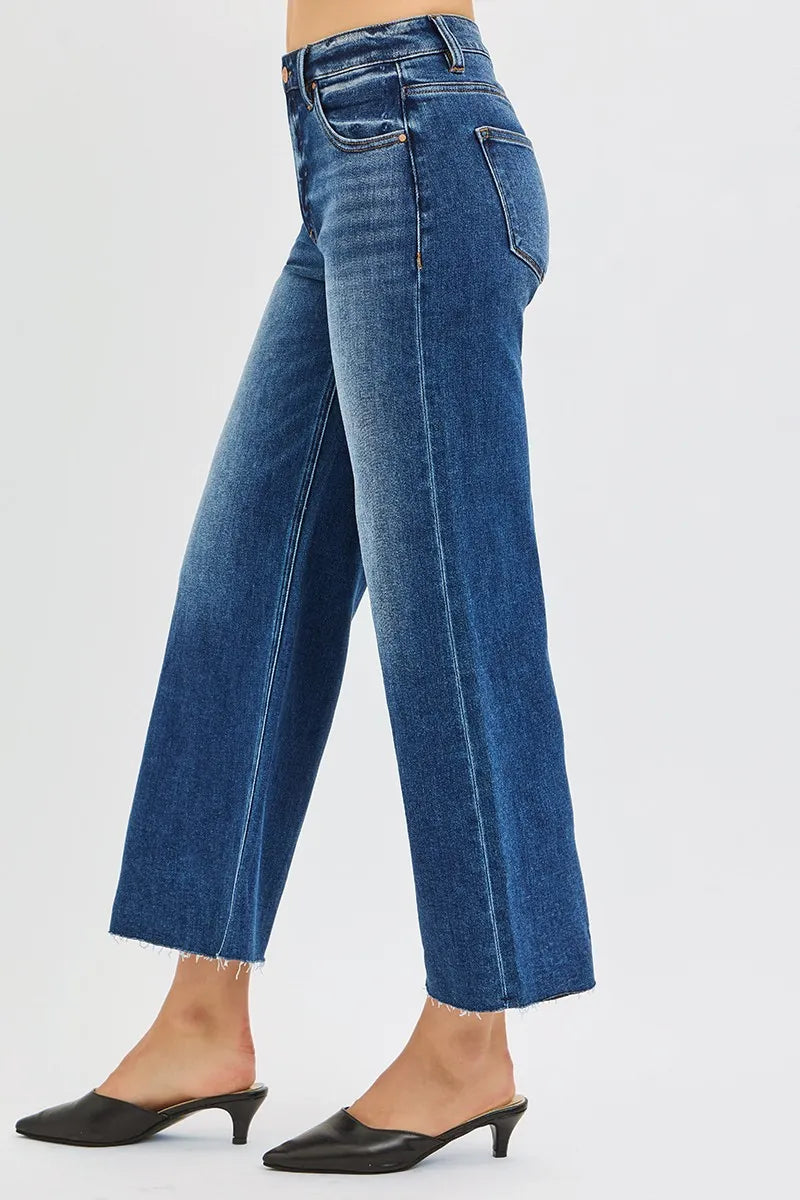 Woman wearing Driftwood Raw Hem Jeans with wide leg cropped fit and raw cut hem.