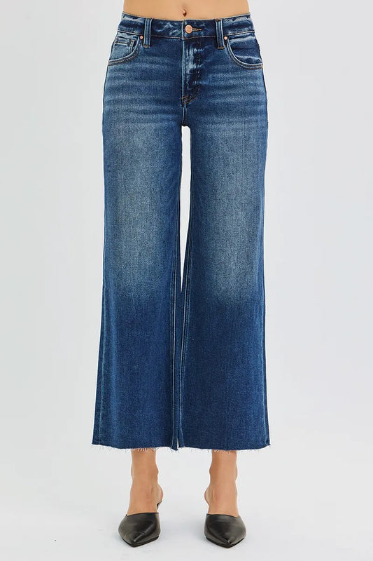 Woman wearing Driftwood Raw Hem Jeans with wide leg cropped fit and raw cut hem.