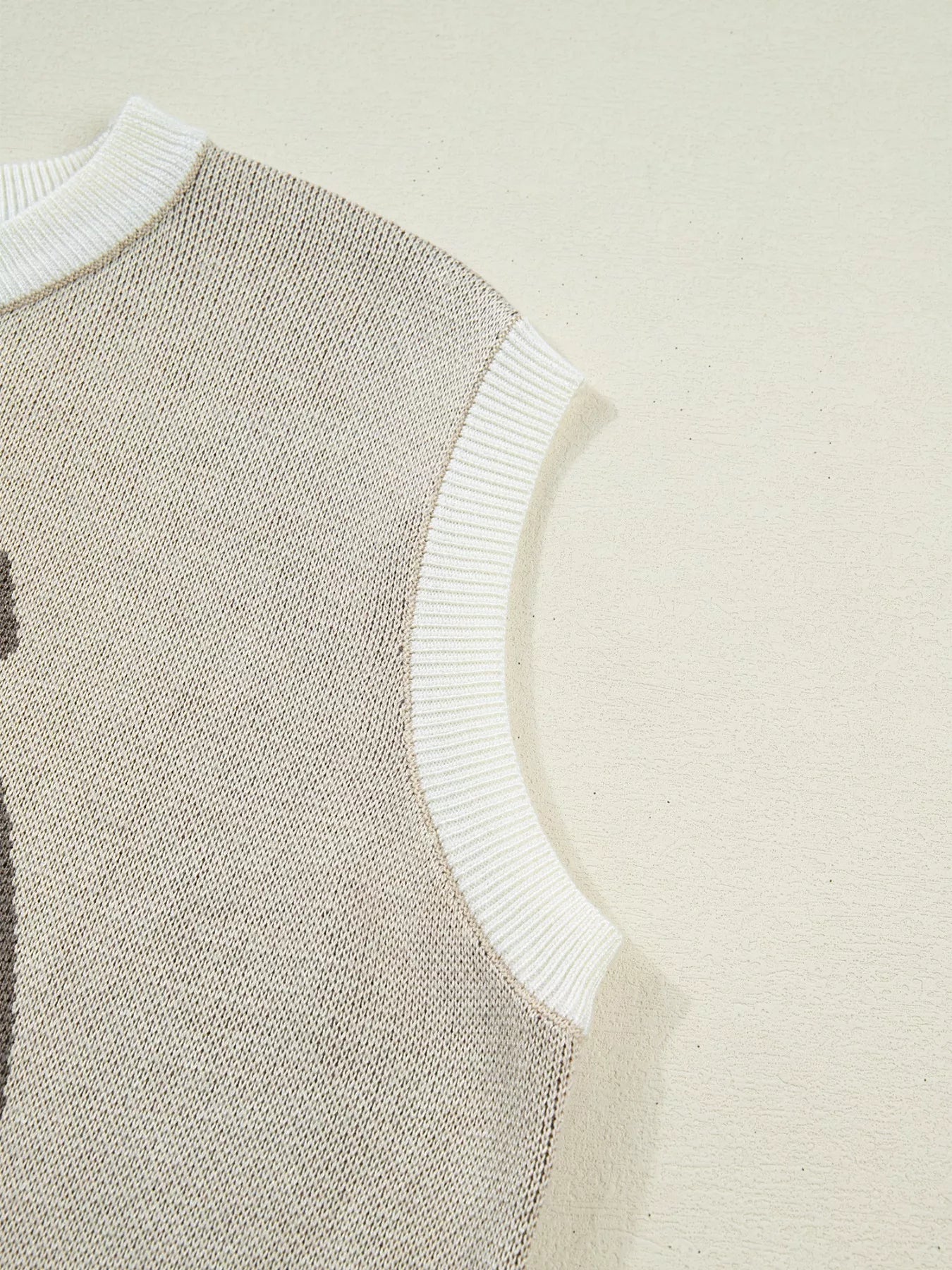 western sweater vest with knitted horse and horseshoe graphic paired with denim shorts