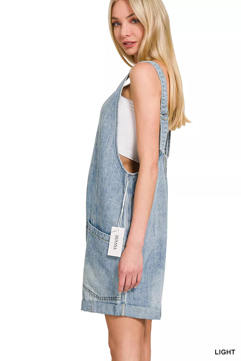 Light wash denim short overalls with front pockets and adjustable straps