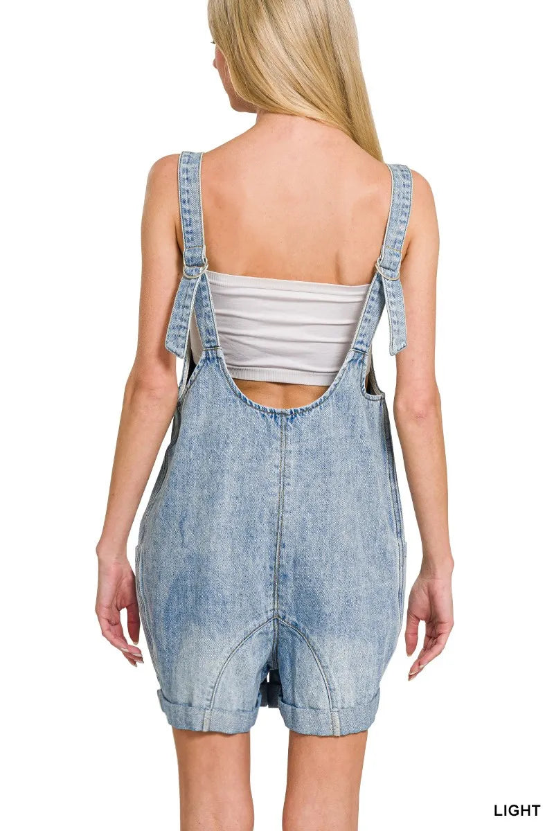 Light wash denim short overalls with front pockets and adjustable straps