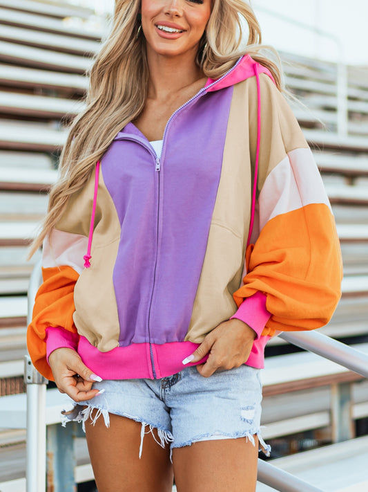 Retro colorblock zip hoodie in pink, orange, purple, and tan with drawstring hood and pockets