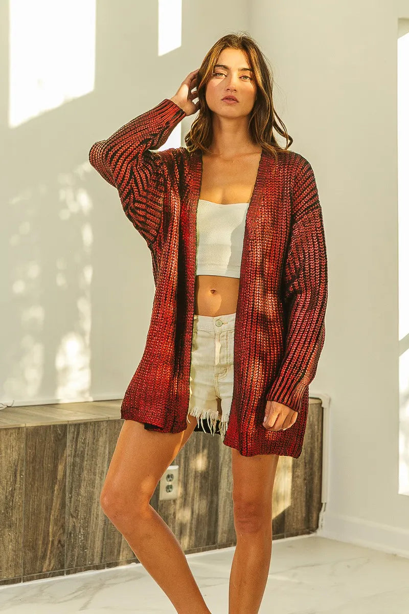 Woman wearing a metallic rust-colored open front knit cardigan with a relaxed fit