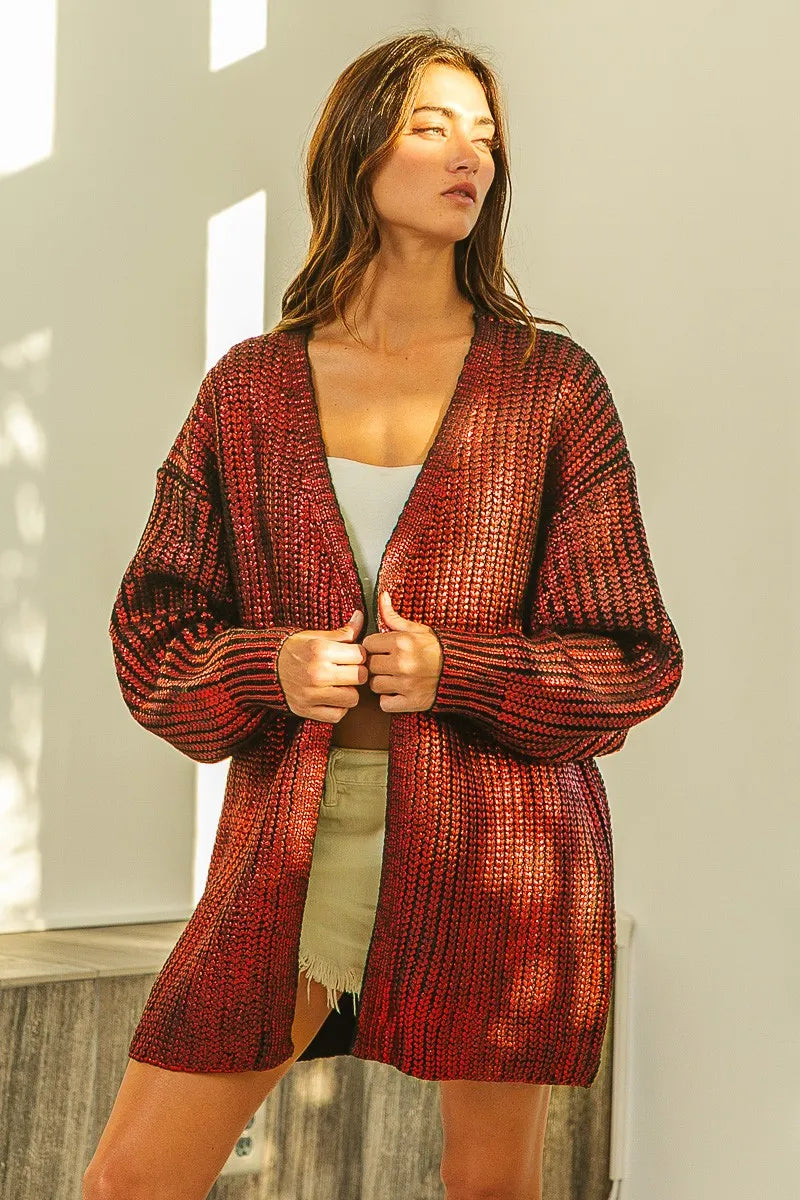 Woman wearing a metallic rust-colored open front knit cardigan with a relaxed fit