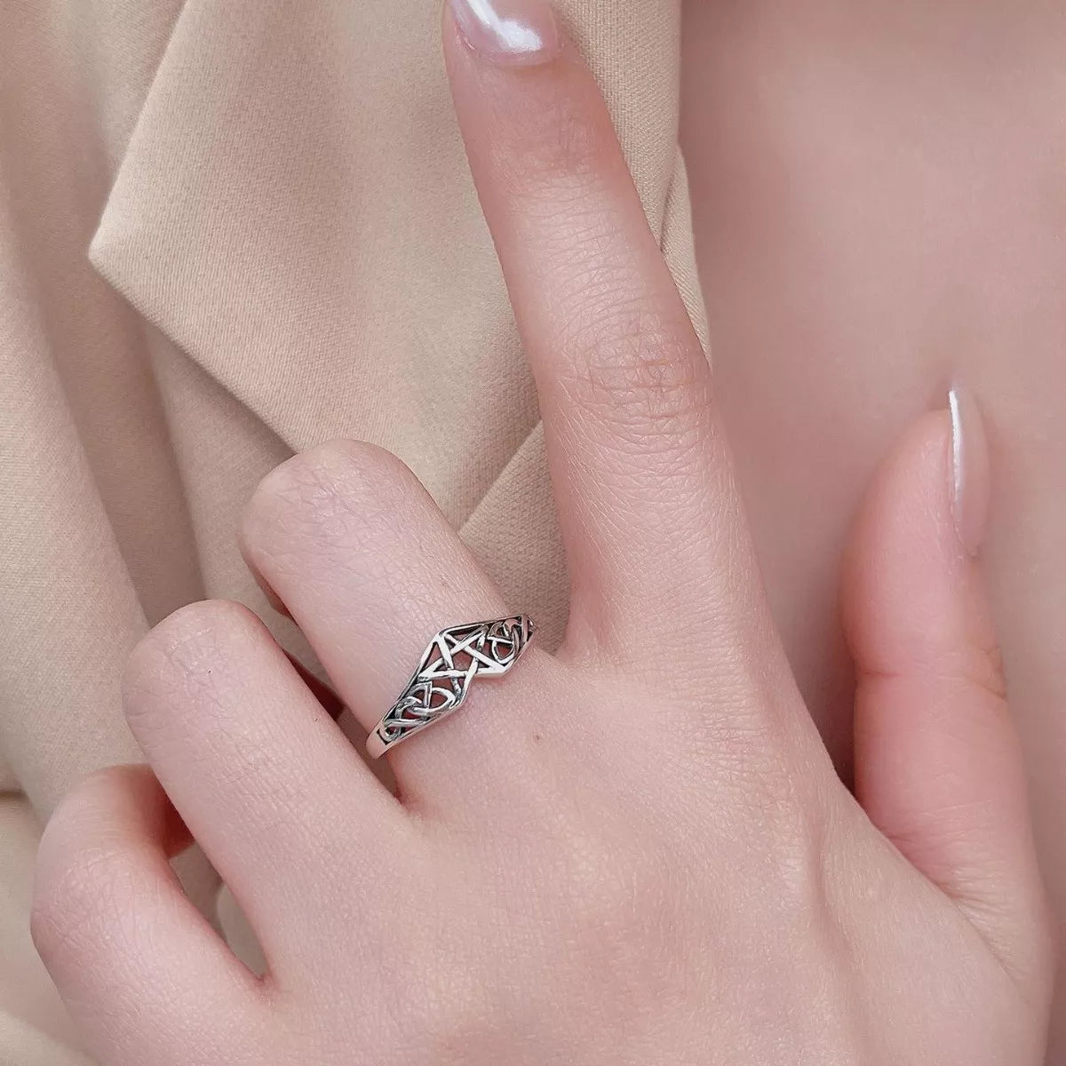 Sterling silver Celtic knot ring with intricate infinity design, crafted in 925 silver and platinum-plated for a polished shine.