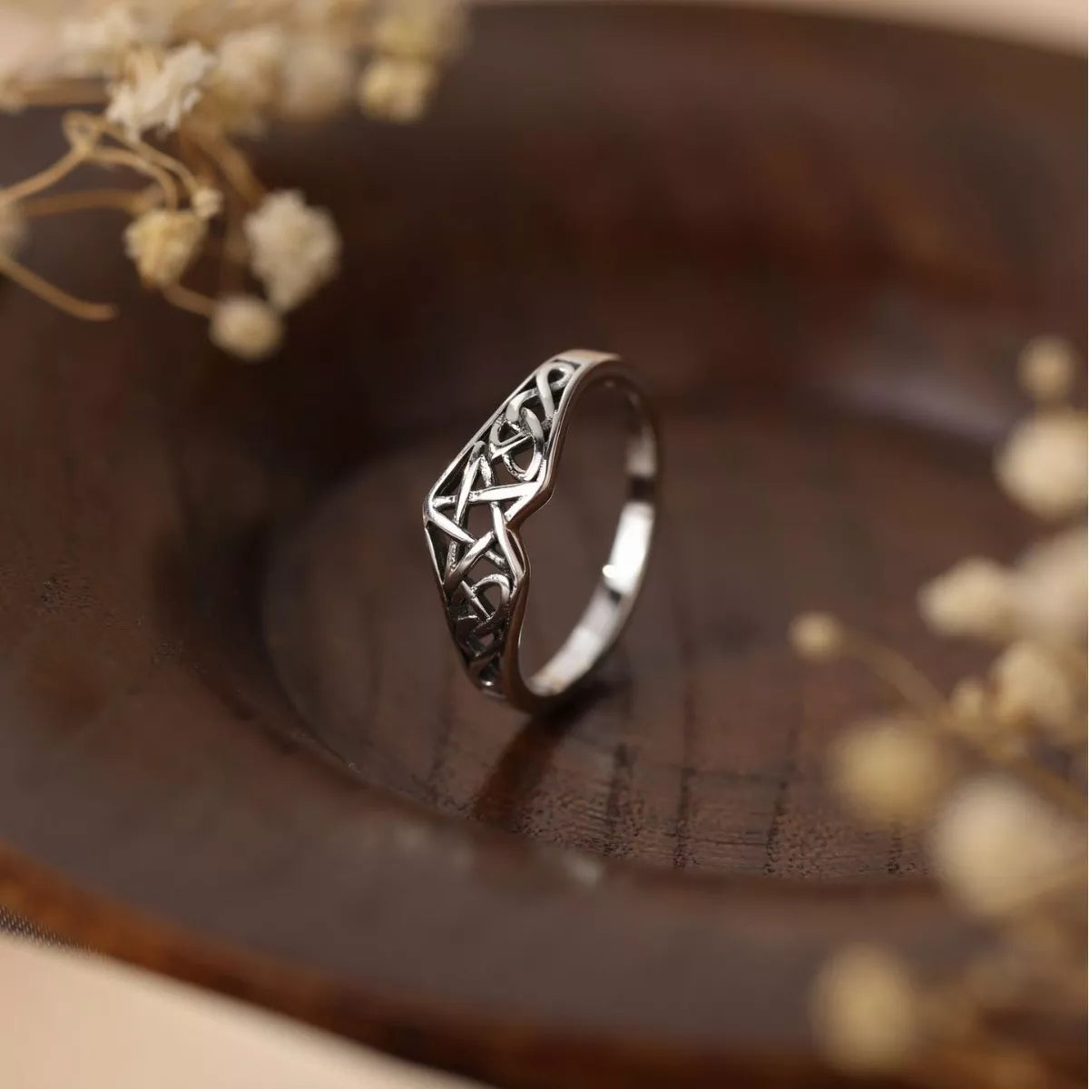 Sterling silver Celtic knot ring with intricate infinity design, crafted in 925 silver and platinum-plated for a polished shine.