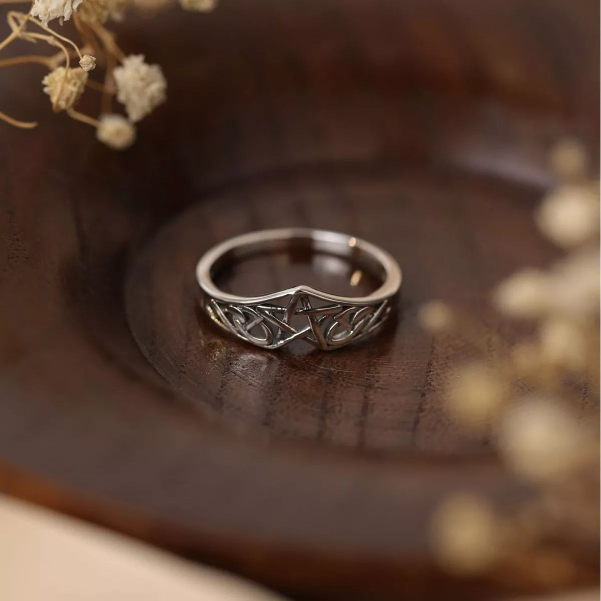 Sterling silver Celtic knot ring with intricate infinity design, crafted in 925 silver and platinum-plated for a polished shine.