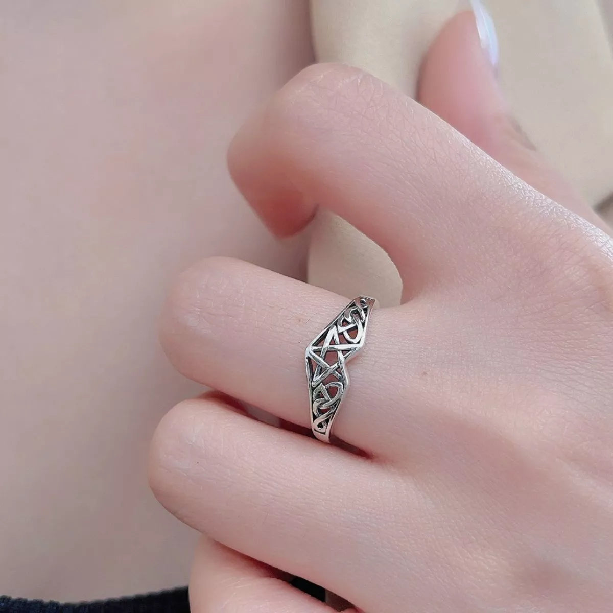 Sterling silver Celtic knot ring with intricate infinity design, crafted in 925 silver and platinum-plated for a polished shine.