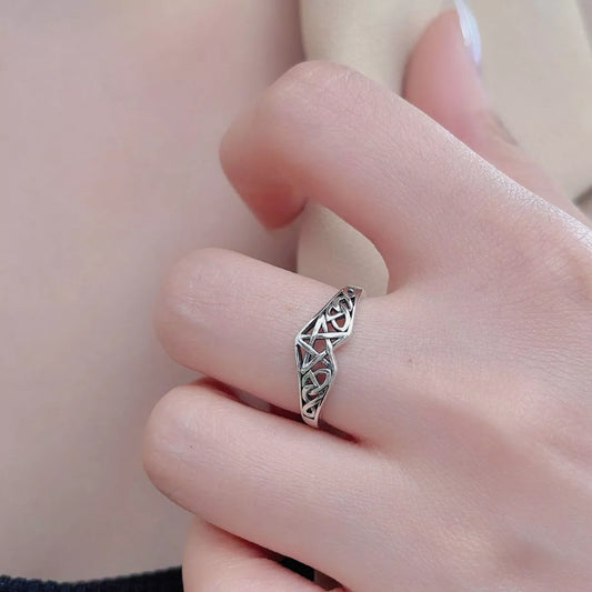 Sterling silver Celtic knot ring with intricate infinity design, crafted in 925 silver and platinum-plated for a polished shine.