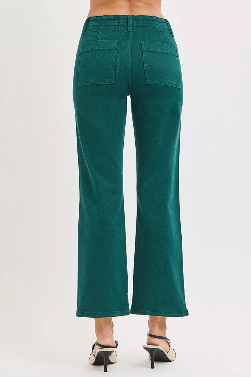 Woman wearing emerald green high-rise corduroy pants with patch pockets and ankle-flare fit — winter chic look from A Whimsical Affair.