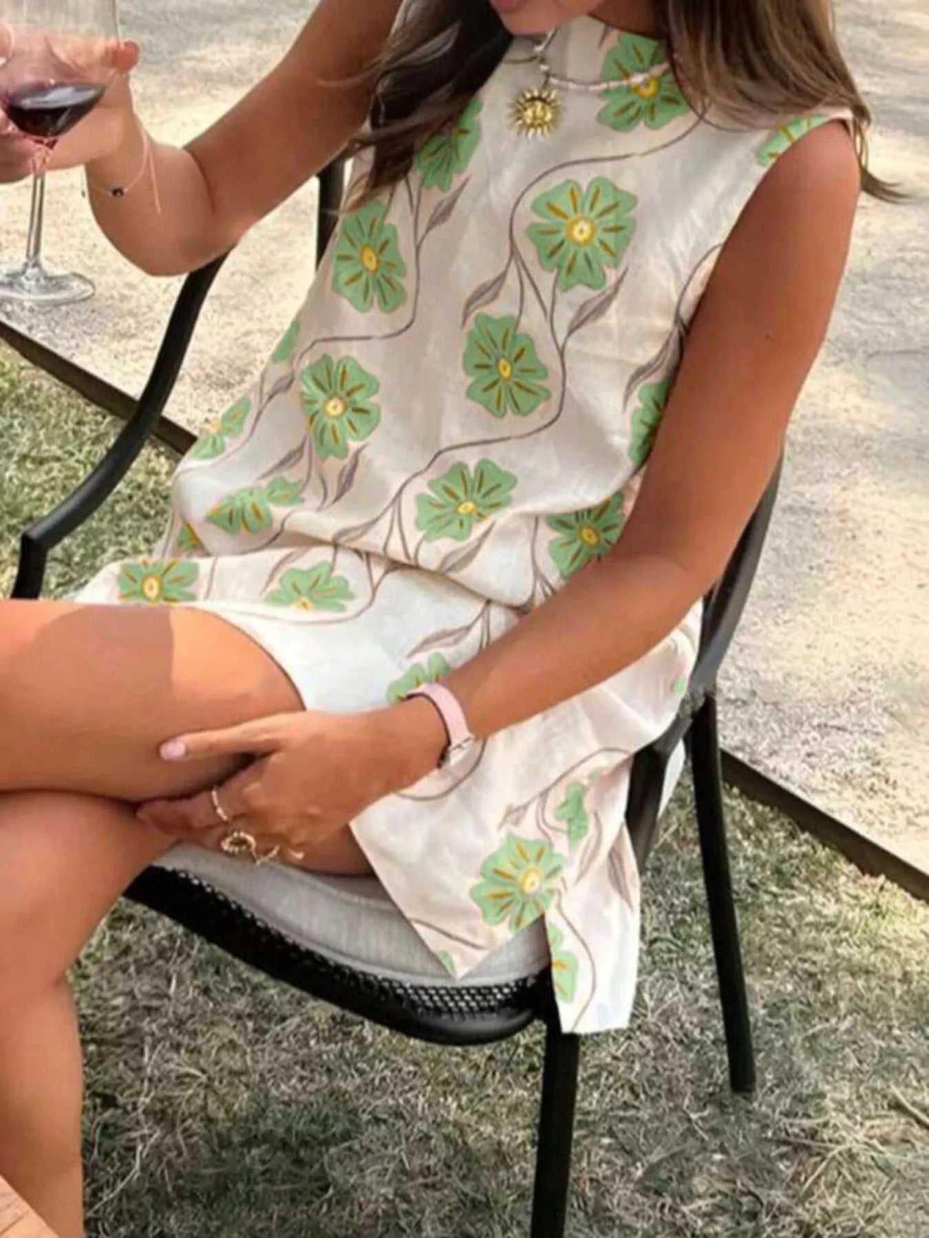 Sleeveless floral mini dress with relaxed swing silhouette and lightweight fabric.