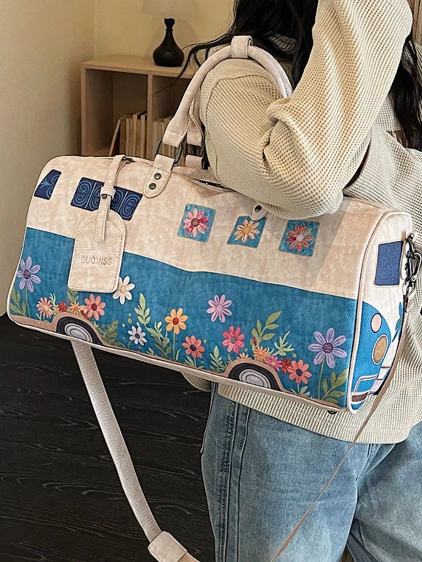Large flower power microbus weekender bag with blue retro van design, floral details, handles, and shoulder strap.