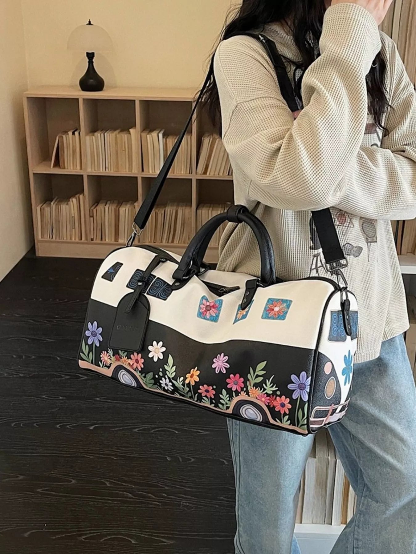 Large flower power microbus weekender bag with blue retro van design, floral details, handles, and shoulder strap.