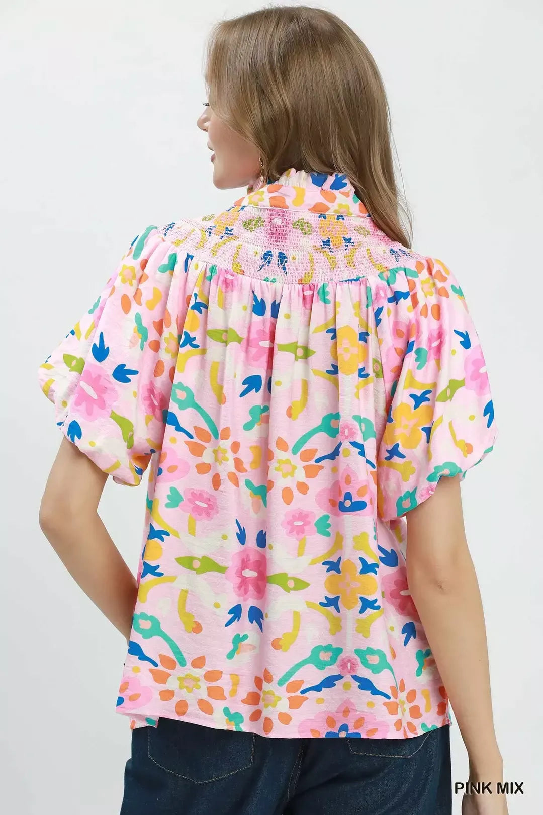 Pink mix folk art floral blouse with smocked neckline detail, split collar, puff sleeves, and relaxed boxy fit.
