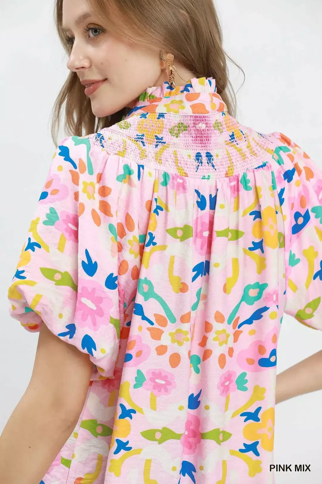 Pink mix folk art floral blouse with smocked neckline detail, split collar, puff sleeves, and relaxed boxy fit.