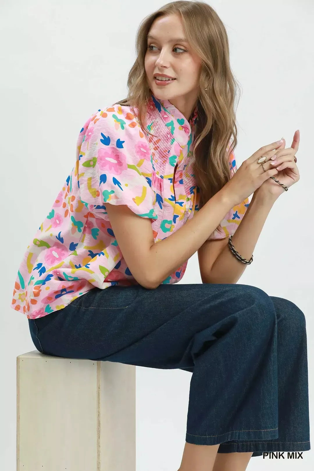 Pink mix folk art floral blouse with smocked neckline detail, split collar, puff sleeves, and relaxed boxy fit.